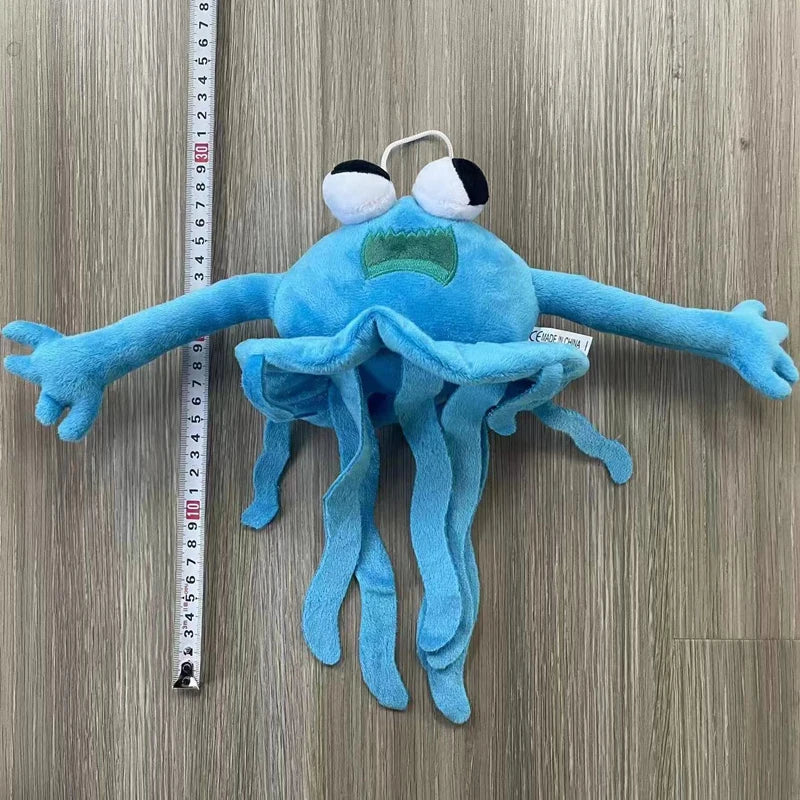 A soft blue plush toy resembling an octopus or squid with large eyes and tentacles.