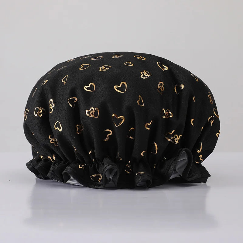 Black reusable elastic shower cap with gold heart pattern