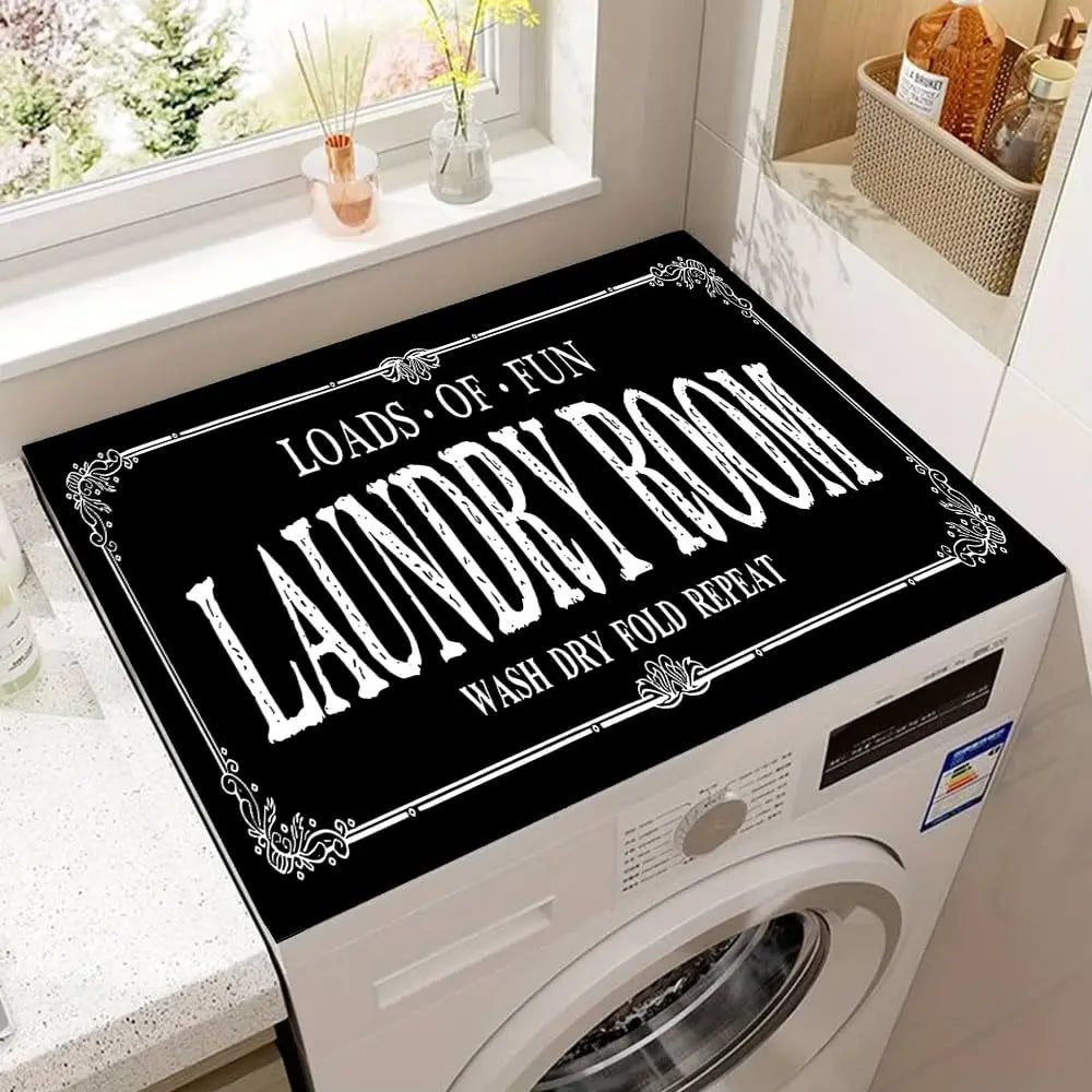 A laundry room with a white washing machine featuring a black mat that reads Loads of Fun Laundry Room Wash Dry Fold Repeat