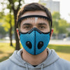 A young man wearing a blue reusable cycling face mask with a clear shield over his face outdoors.
