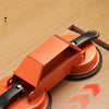 An orange floor gap repair tool with a suction cup is shown on a light wood floor.