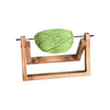 A green yarn ball is mounted on a wooden rotating holder with a stable base.