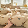 A beige duvet cover set featuring a cute dog print design with pillows and bedding.