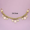 A gold-colored decorative chain phone strap featuring small white flower charms and a lobster clasp.