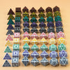 A collection of multi-sided polyhedral dice in various colors and shapes arranged in a grid.