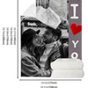 A custom photo flannel blanket with a gray background and a red heart embroidered on the side.