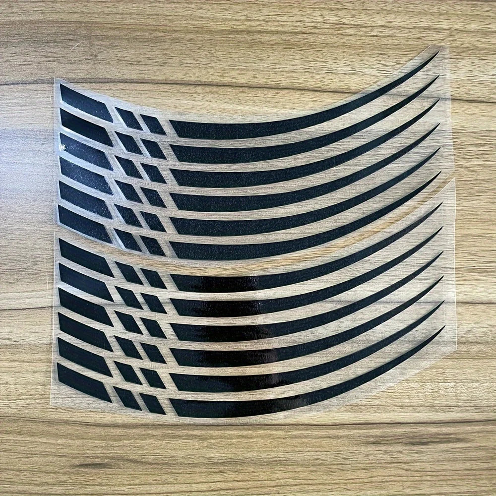 A set of black and brown vinyl decals featuring curved stripes and geometric patterns for motorcycle wheel rims.
