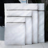 A stack of white fine mesh laundry bags for delicates and everyday wash