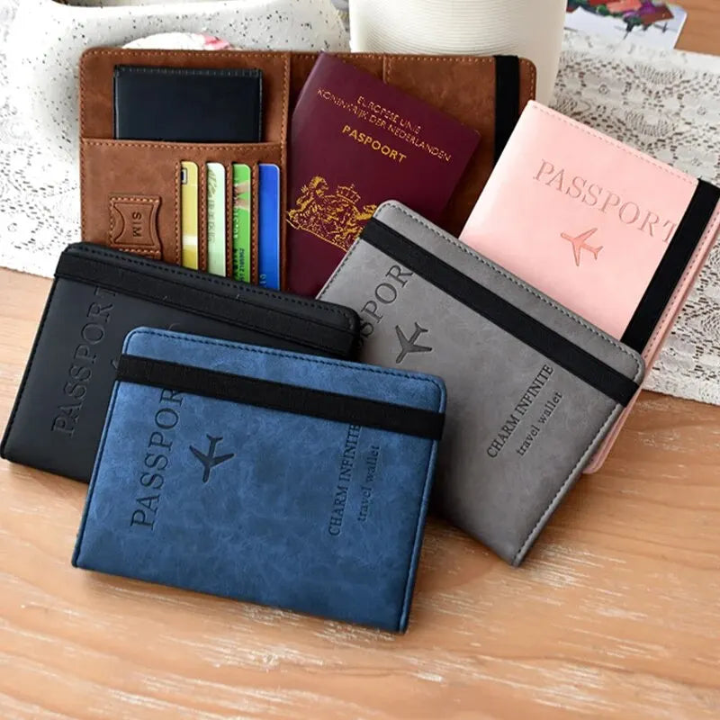 A collection of leather and fabric passport covers and travel wallets in various colors like brown, pink, and blue.