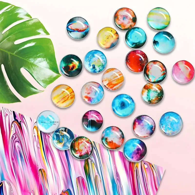 A collection of colorful glass cabochons and magnets arranged on a pink background.
