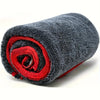 A rolled gray microfiber drying towel with a red accent, showing its texture and absorbent design.