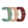 Tres bandas elásticas de colores para rastreadores de fitness: verde, beige y granate.