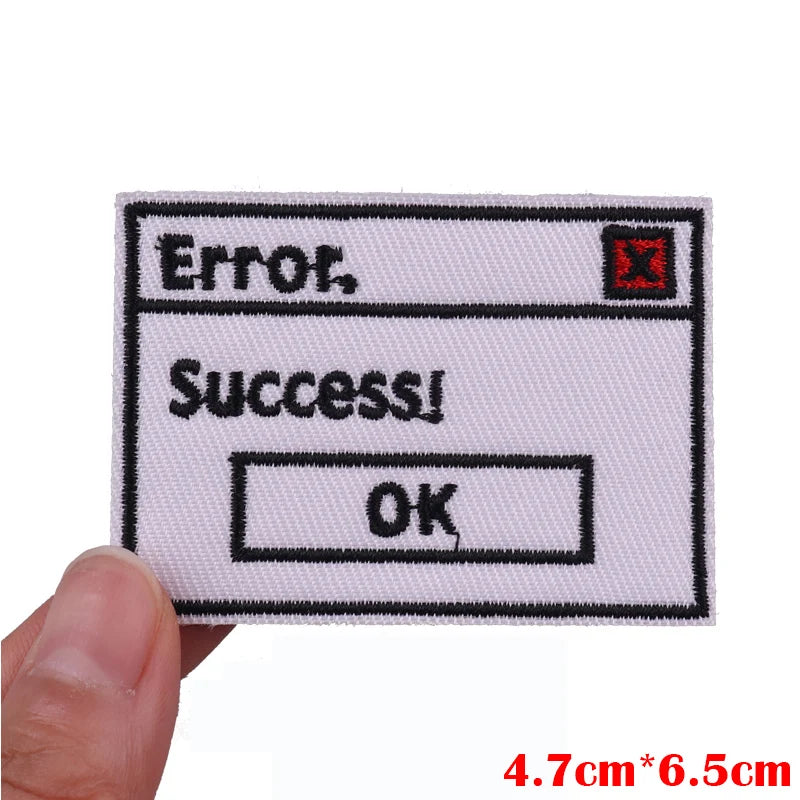 A white embroidered patch showing an error message, success message, and an OK button.