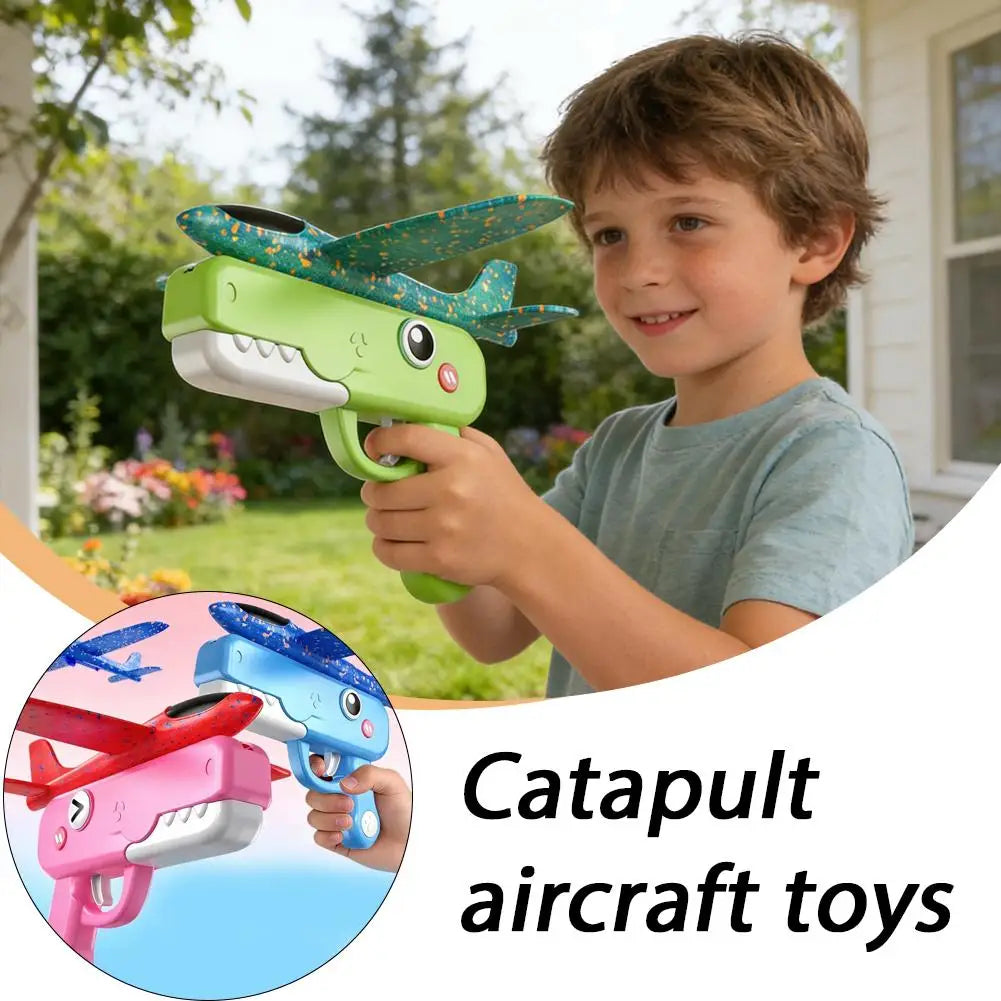 A young boy is holding a green foam catapult airplane toy with a teal wing, demonstrating the product.