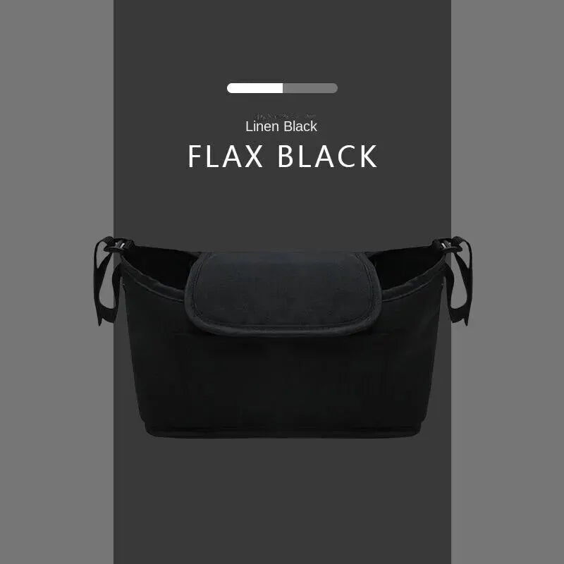 A black flax linen organizer bag for a stroller, shown against a gray background.