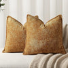 A square, textured, golden brown chenille decorative cushion cover resting on a light-colored sofa.