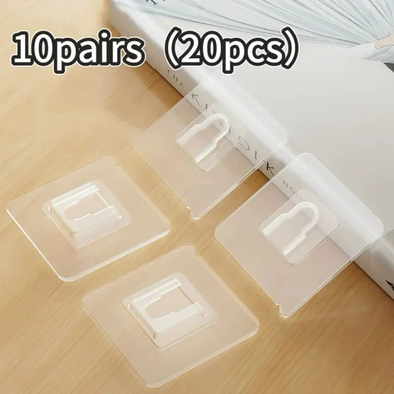 Ten pairs of clear, double-sided adhesive wall hooks are shown on a wooden surface.