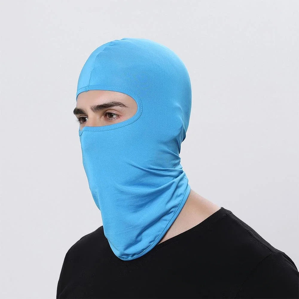 A person wearing a bright blue windproof full face balaclava.