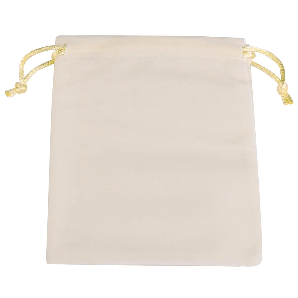 A cream-colored velvet drawstring jewelry pouch with light yellow ties.