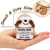 A handmade crochet sloth plush doll with a smiling face and brown fur is held in a person's hand.