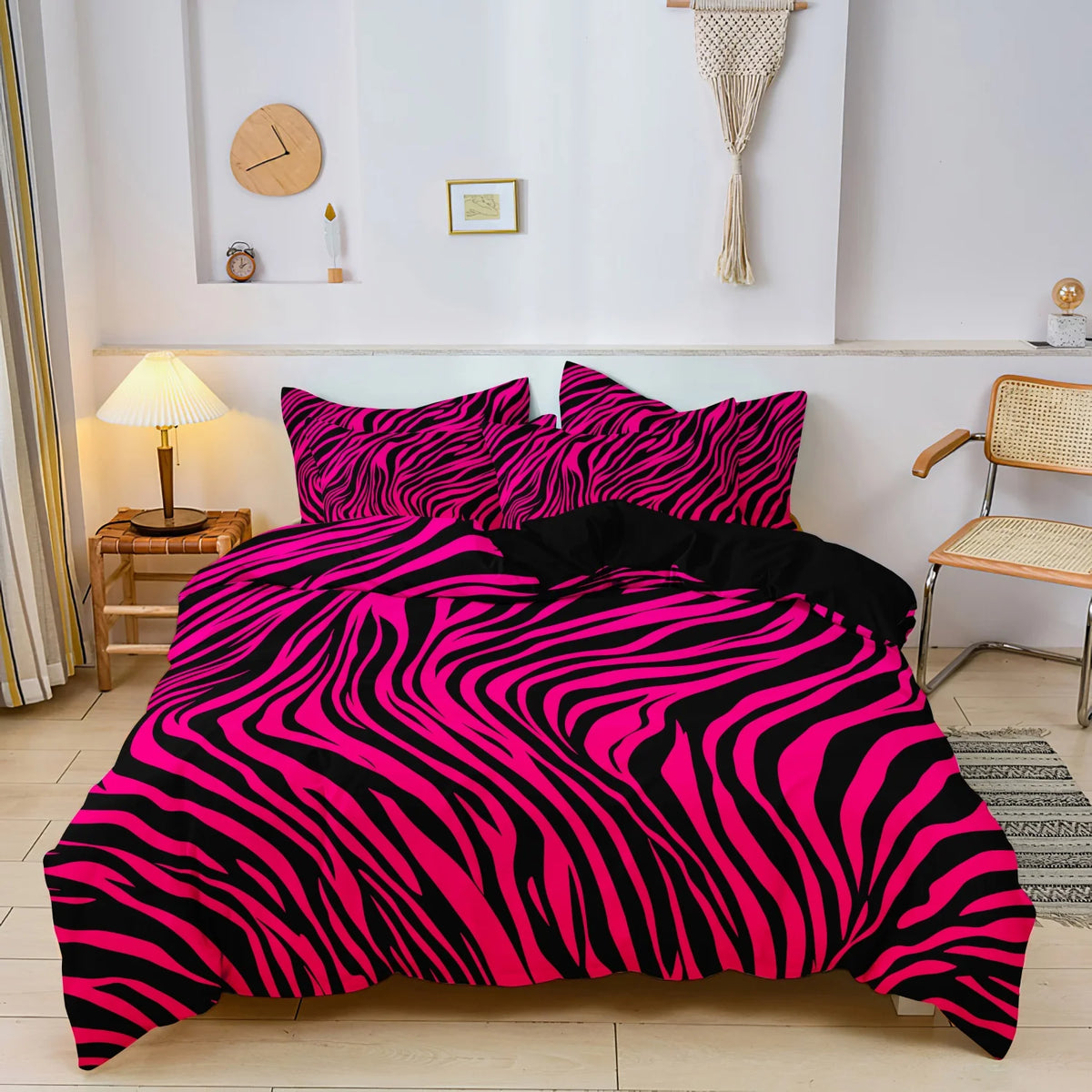 A vibrant pink and black zebra print duvet cover set displayed on a bed in a bright room.