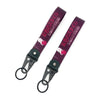 A dark purple keychain featuring an anime girl design with a steel clip.