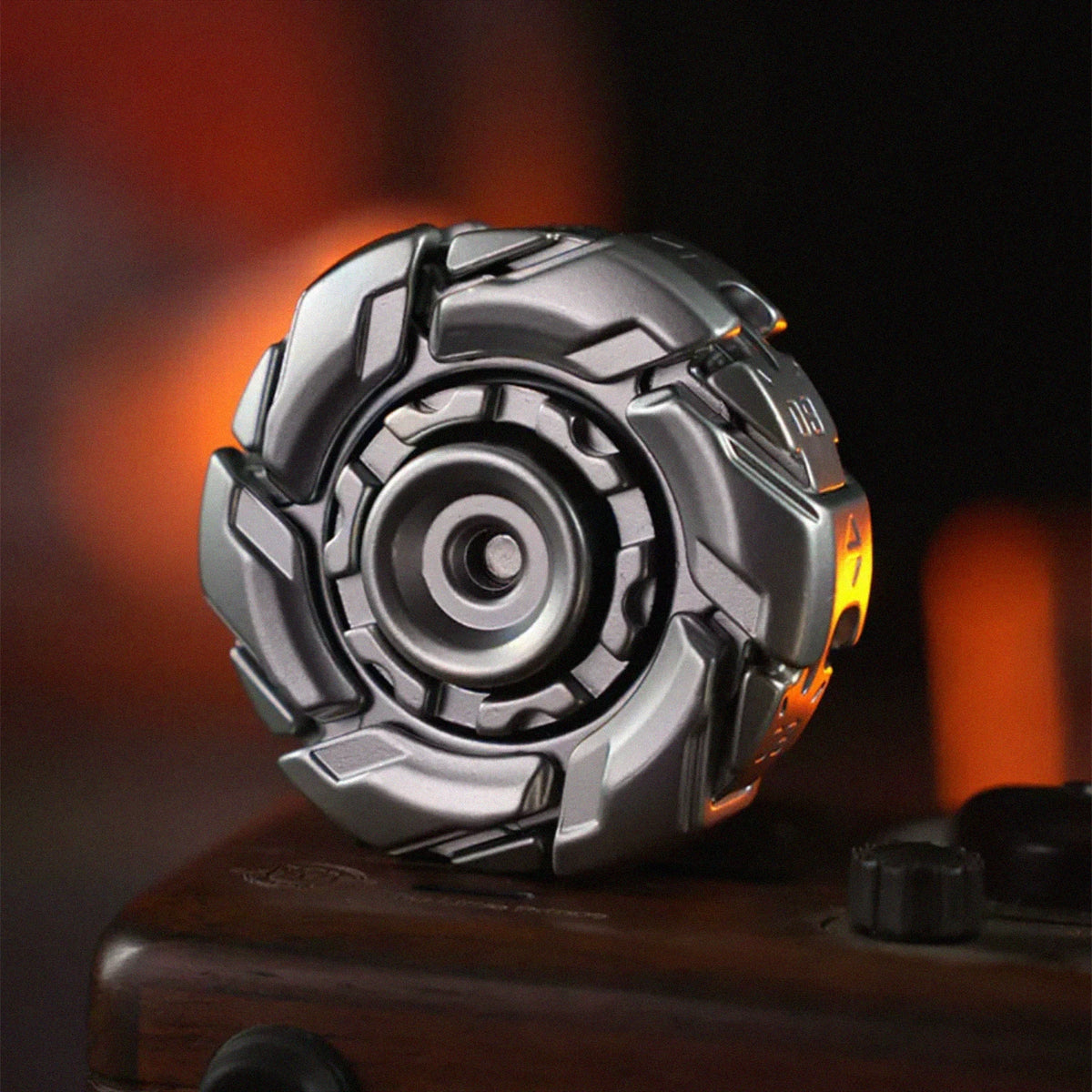A close-up shot of a silver stainless steel fidget spinner resting on a dark wooden surface.