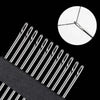 A close-up view of stainless steel self-threading sewing needles against a black background.