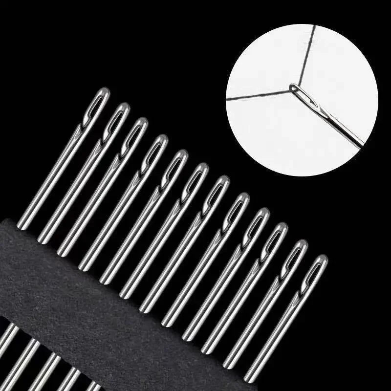 A close-up view of stainless steel self-threading sewing needles against a black background.