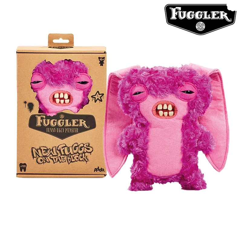 A pink fuzzy plush toy of an ugly monster with funny teeth, packaged in a brown box.