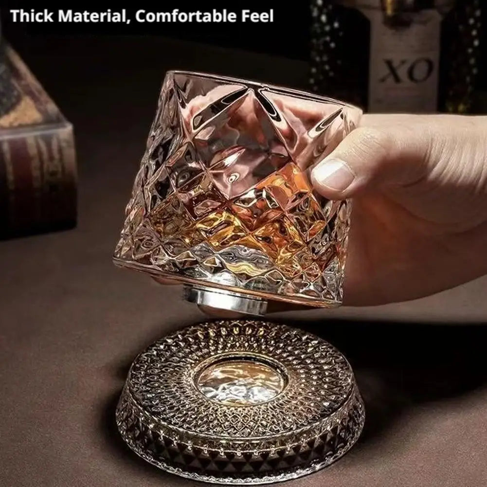 A hand holds a textured crystal whiskey glass with a decorative base and a lid, showcasing the thick material and comfortable