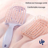 A light pink volumizing detangling hair comb is shown next to a larger version, emphasizing comfortable massage.