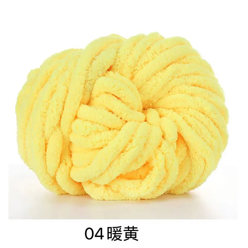 A ball of bright yellow chunky acrylic yarn used for knitting and crochet
