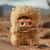 A fluffy, light brown collectible blind box featuring a face and ears, set in a desert landscape.