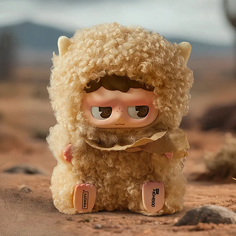 A fluffy, light brown collectible blind box featuring a face and ears, set in a desert landscape.