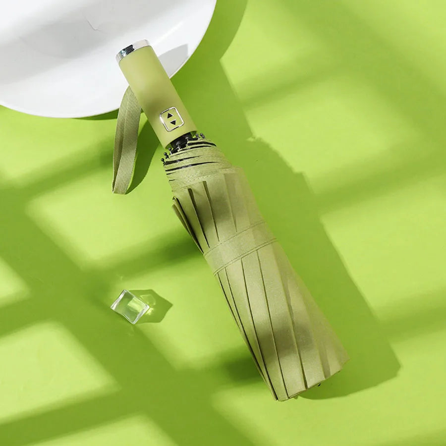 A beige automatic foldable umbrella with a gold accent is shown against a bright green background.