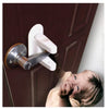 A young child is interacting with a white door lever lock and latch mechanism on a dark wooden door.