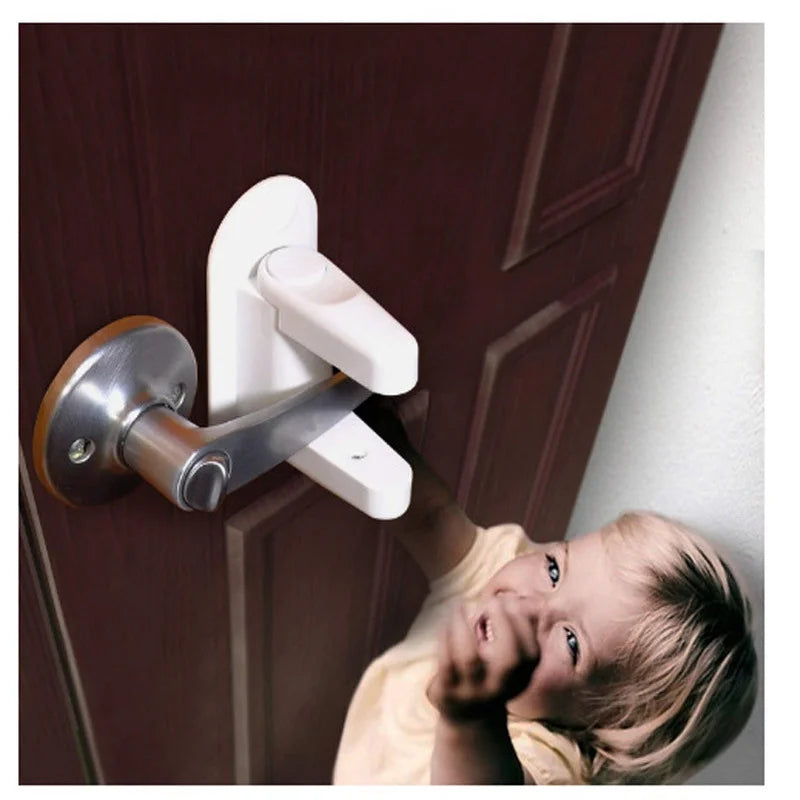 A young child is interacting with a white door lever lock and latch mechanism on a dark wooden door.