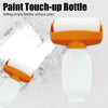 An orange paint touch-up bottle with a roller applicator and a white refill cartridge.