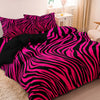 A vibrant pink and black zebra print duvet cover set displayed on a bed.
