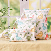 A set of reusable waterproof wet bags featuring various dinosaur patterns in green, yellow, and pink on a light background.