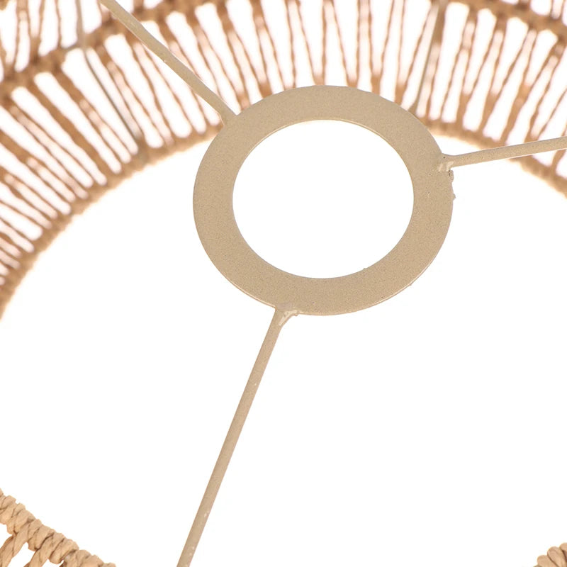 A close-up view of a woven paper rope pendant lampshade with a circular element and thin rod.