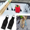 Two black EZ Bed Anchor no-drill tie-down straps are shown with a red anchor and a tire mounted on a truck tailgate.