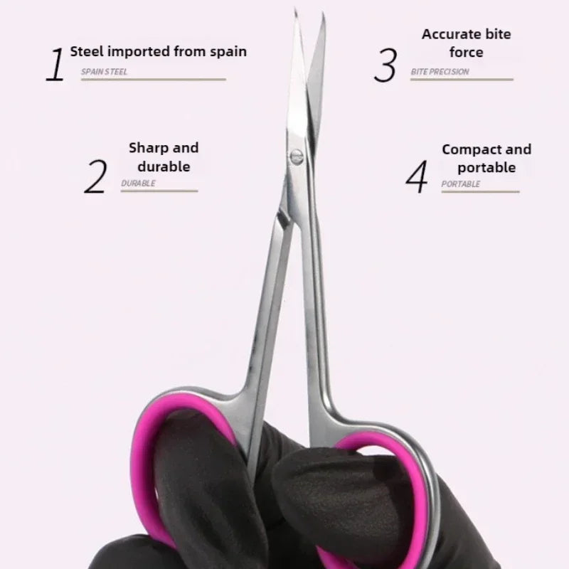 A pair of professional stainless steel cuticle scissors held by a gloved hand, demonstrating their compact and portable desig
