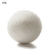 A single white natural wool dryer ball is shown against a white background.