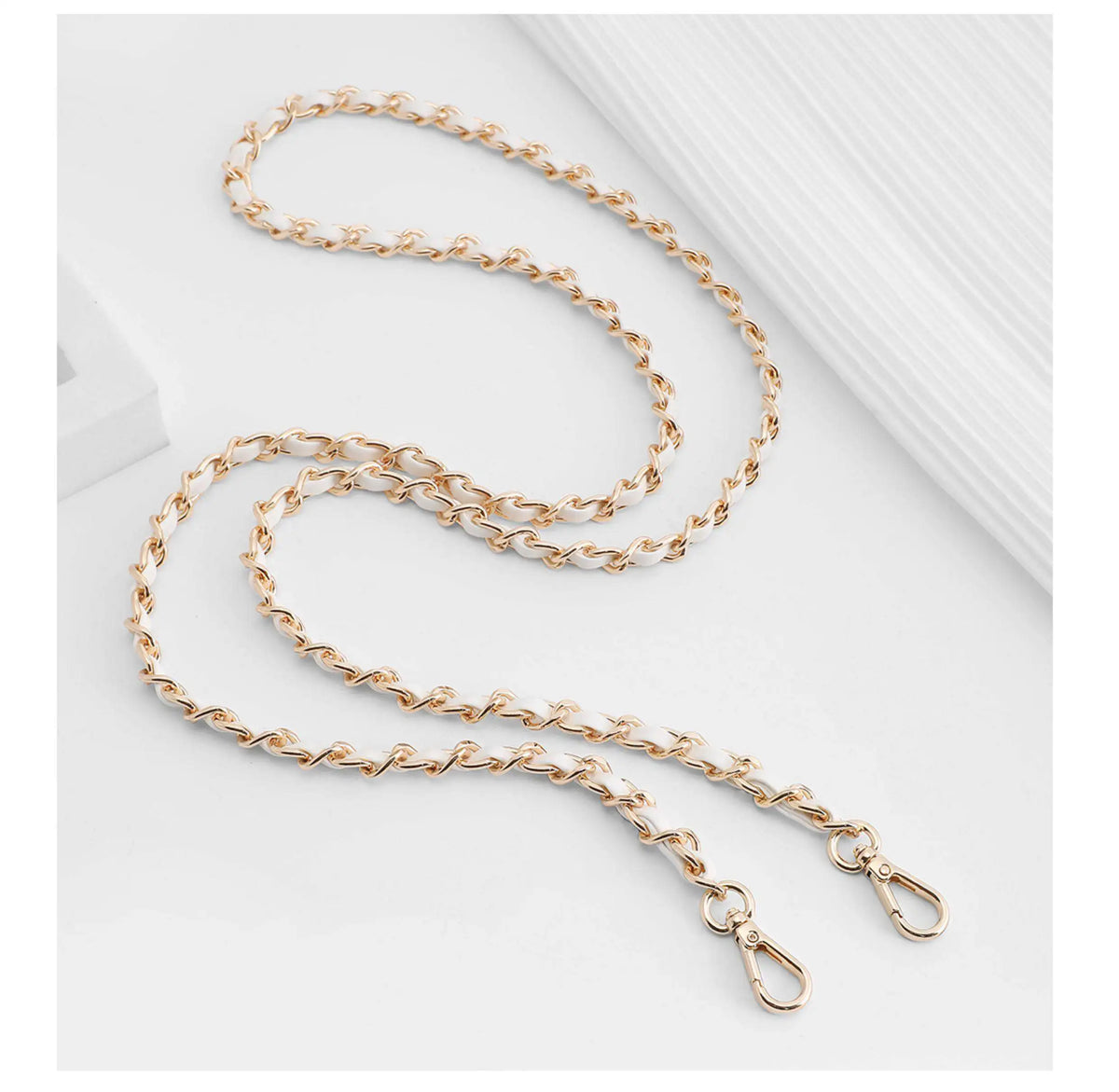 Gold-toned metal chain shoulder strap buckle for a crossbody bag