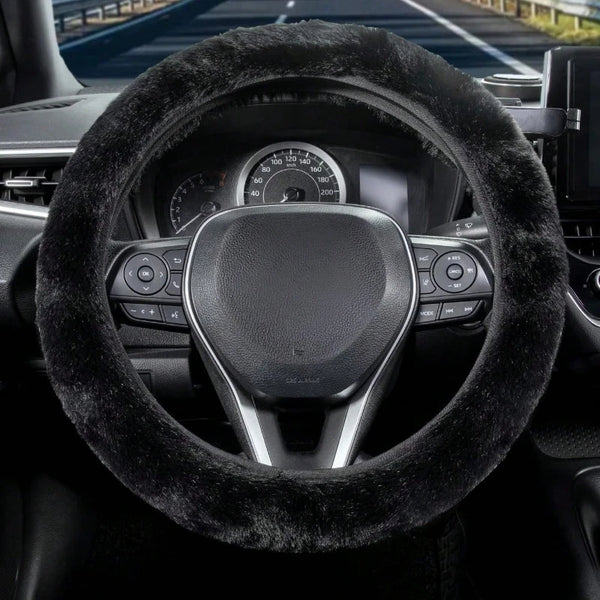 Close-up view of a black winter plush steering wheel cover on a car's interior.