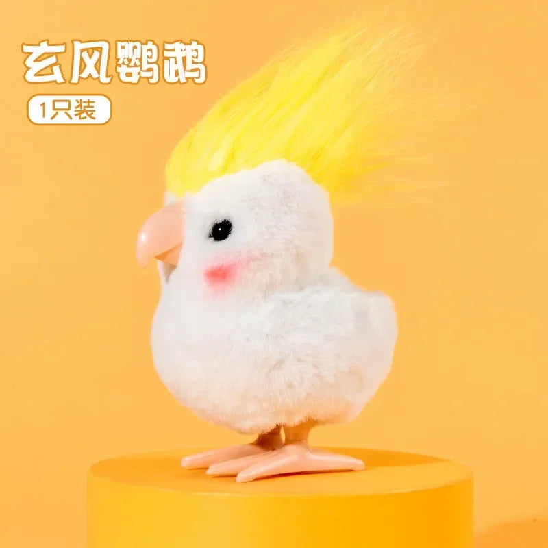 A white chicken toy with bright yellow feathers and pink accents, standing on an orange base.