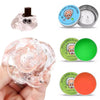 Crystal clear stress putty in a silver tin next to a pink glass rose product.