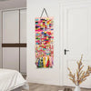 A colorful hair bow and clip organizer with a rope hanger displayed on a white wall.